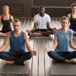 A diverse group peacefully meditates in a yoga class scaled 11zon
