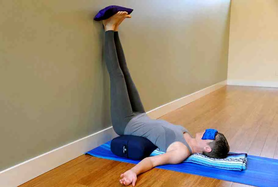A man practicing yoga on a mat.