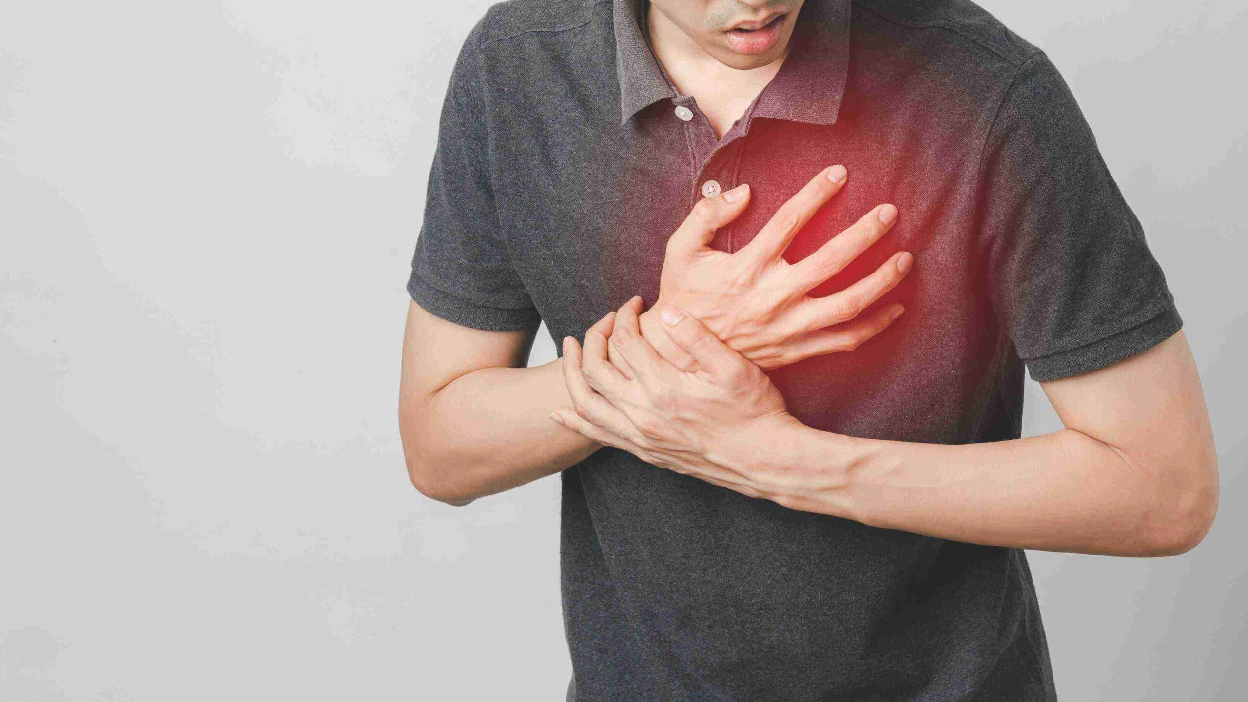 Person holding chest due to suspected heart attack.