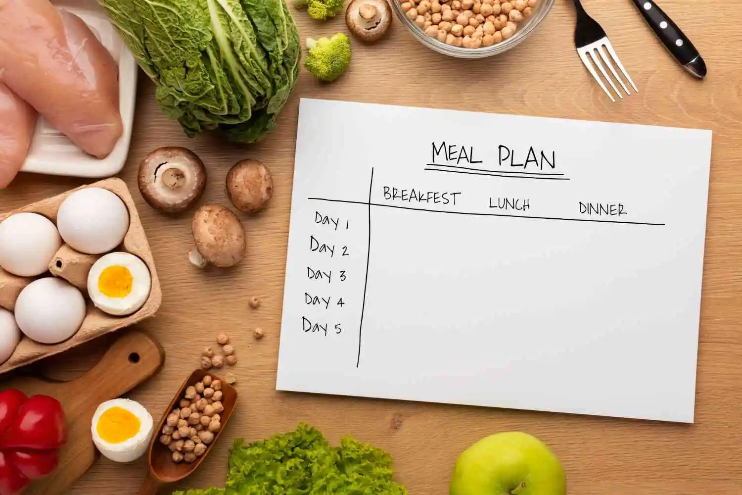 A table with a meal plan featuring vegetables, eggs, and other healthy foods.