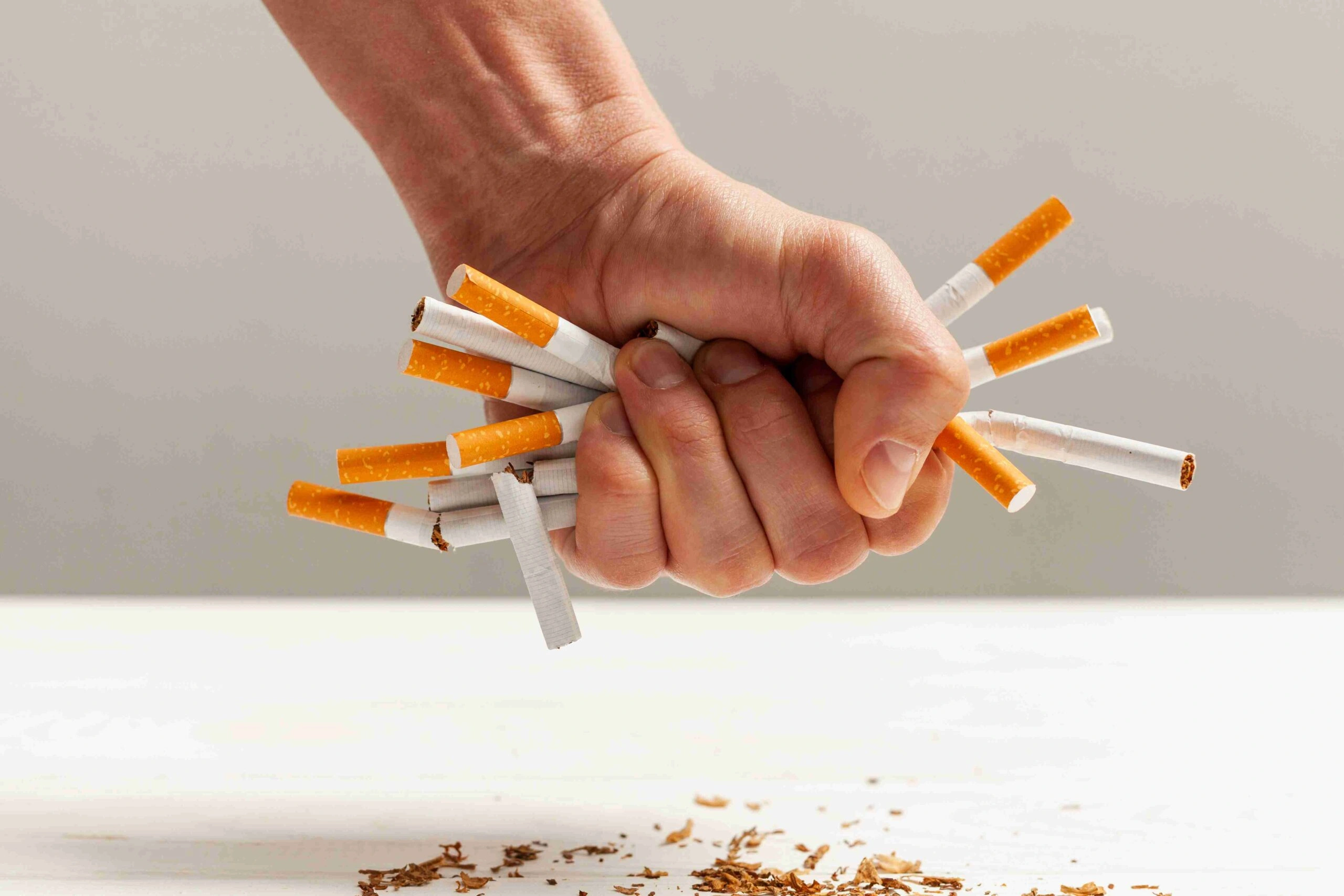 Hand holding lit cigarette